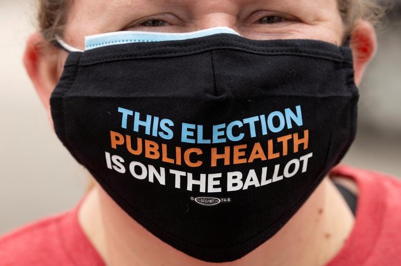 A teacher joins in with healthcare workers during a protest for Personal Protective gear at Kindred Hospital Westminster, a 109-bed long-term care facility in Westminster, California. REUTERS/Mike Blake    